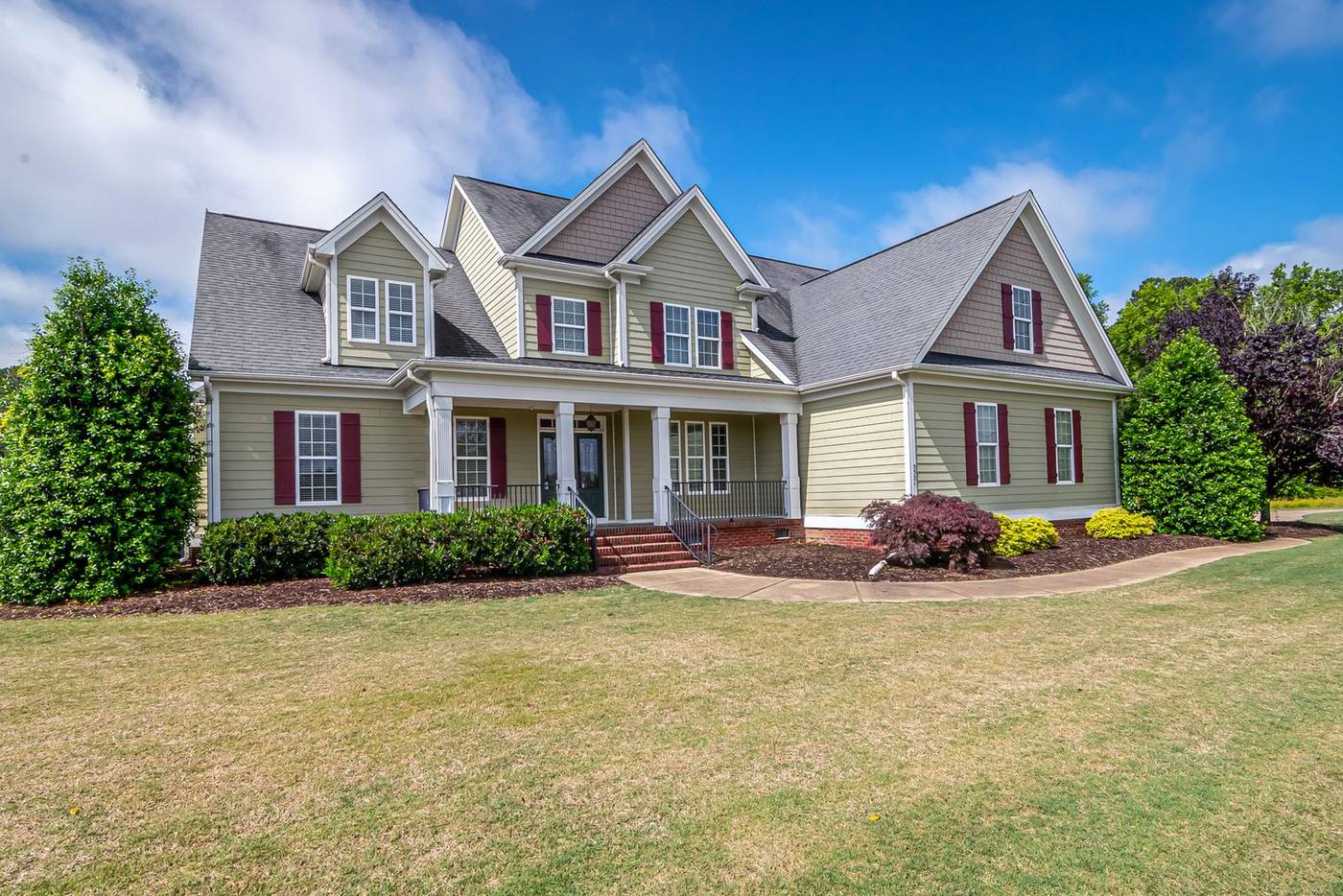 Craftsman-style suburban home with a broad lawn